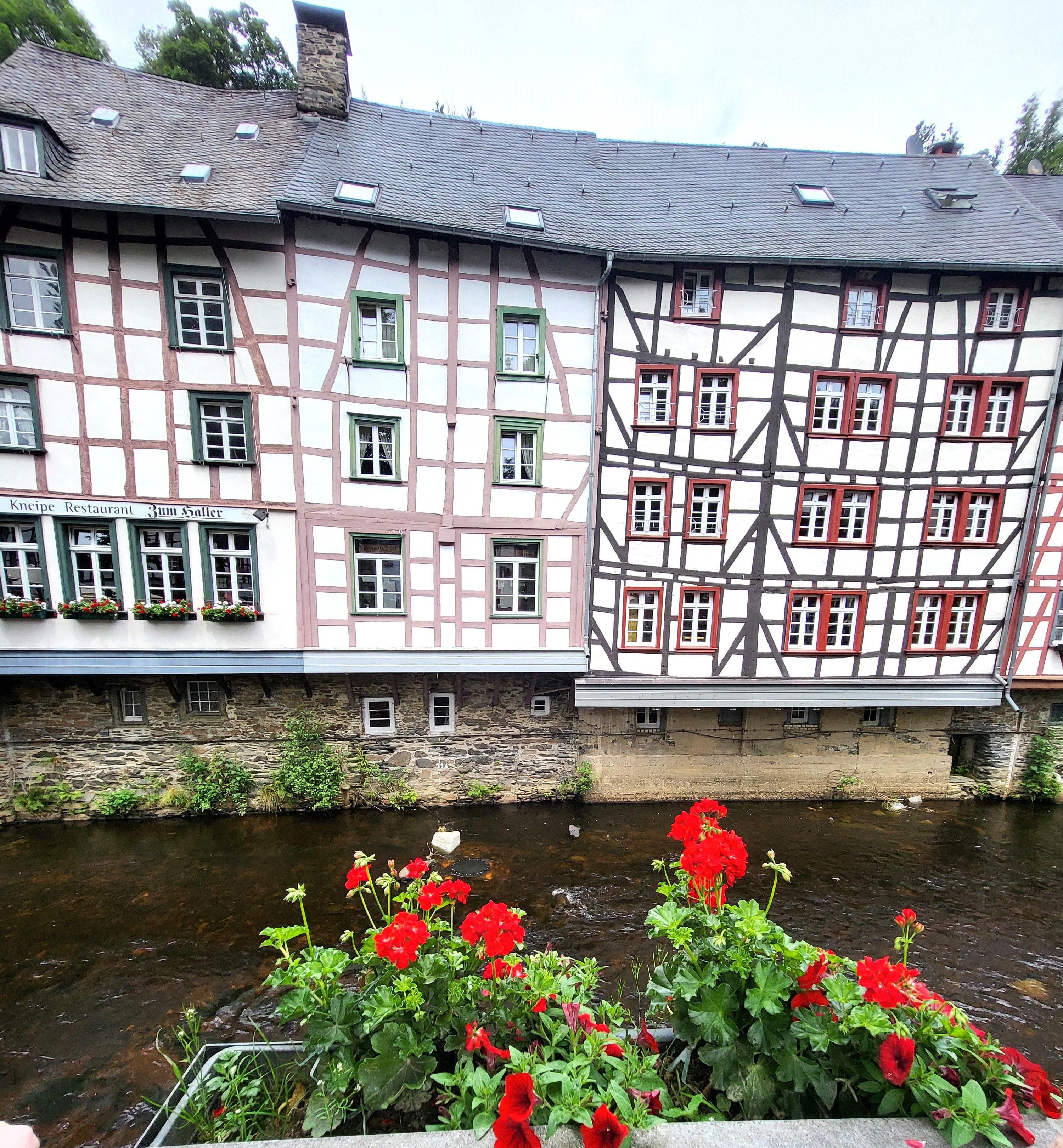 Half-timbered houses with flowers by a stream